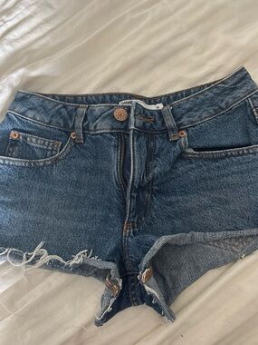 Garage Distressed High-Rise Denim Cutoff Shorts in Medium Blue